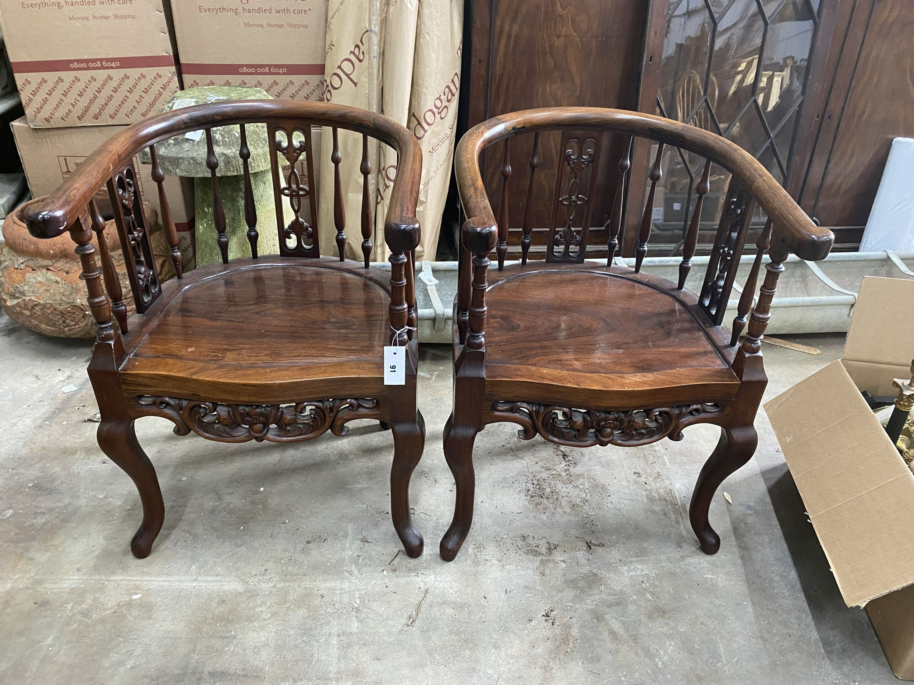 A pair of Chinese carved hardwood elbow chairs, width 55cm, depth 50cm, height 79cm